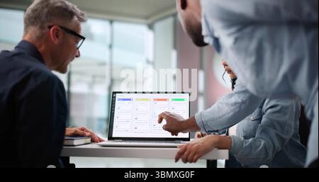 Multicultural Project Team Collaborates Using Various Management Techniques And Software. Stock Photo