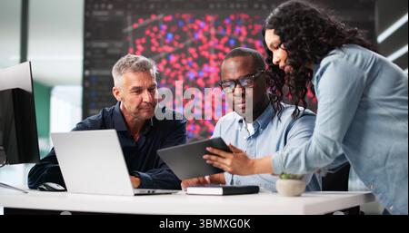 Black Engineer Using Laptop In Professional Cyber Security Team Office Stock Photo