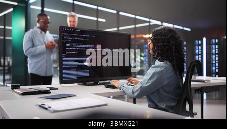 Multiracial Programming Team Working Together To Develop Innovative Software Solutions. Stock Photo