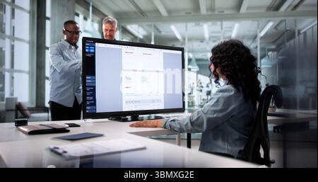 Diverse Team Of Chartered Accountants Working Together On Office Computer. Woman And Man Calculating Budget And Taxes Stock Photo