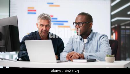 Multiracial Office Team Using Gantt And Kanban Boards For Efficiency. Stock Photo