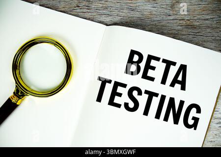 Beta Testing text written on chalkboard with alarm clock on wooden background Stock Photo