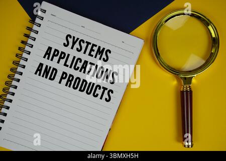 SAP Systems Applications and Products text with magnifying glass on yellow background Stock Photo