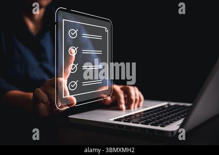 Woman using tablet, laptop futuristic digital interface icons manages checklist online quality control document management system streamlining workflo Stock Photo