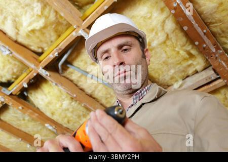 man drilling in construction site Stock Photo