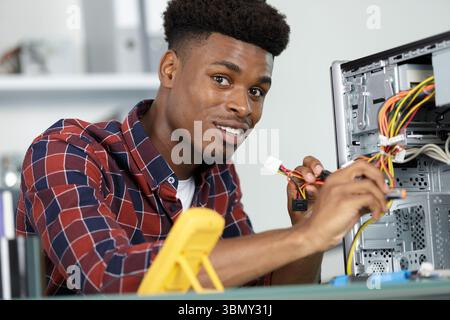 male technician working on a broke pc Stock Photo