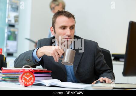 man in black tshirt sit in front of notebook waiting Stock Photo