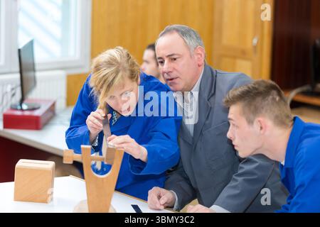 carpenter with students in workshop Stock Photo