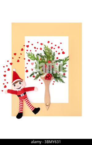 Christmas magical art with santa elf toy, paintbrush, red hearts, holly berries vibrant festive flora on white, gold frame. Fun Xmas design. Stock Photo