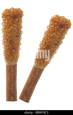 it is two rock sugar sticks with cinnamon for coffee isolated on white. Stock Photo