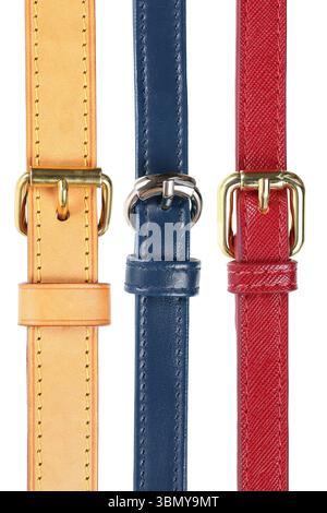it is three leather belts and buckles isolated on white. Stock Photo