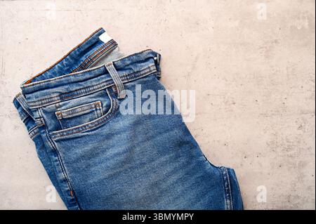 Folded blue classic jeans on desk with space for idea as flat lay Stock Photo