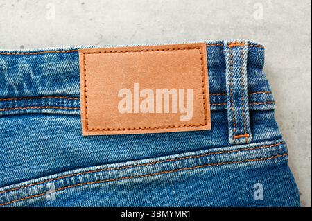 Top view of blue jeans with blank brown label, tag Stock Photo