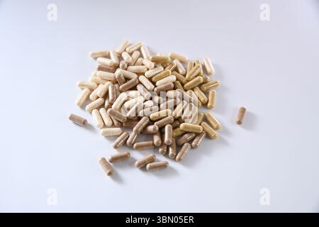 a handful of brown and beige capsules Stock Photo