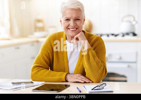 Happy senior woman freelancer working from home Stock Photo