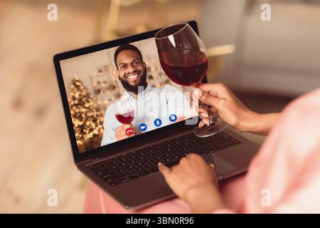 Black couple having online date, drinking wine Stock Photo