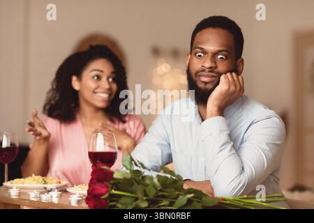 Black Man On Unsuccessful First Date In Restaurant Stock Photo