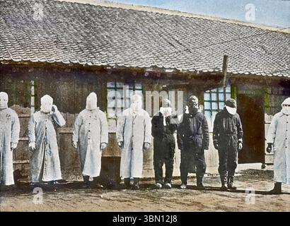 Plague workers wearing protective clothing during Manchurian plague of 1910 Stock Photo