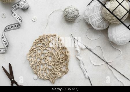 Yarn balls, knitting needles and measuring tape on white background Stock Photo
