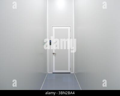 Scene of narrow corridor with finger scanner of entrance door room and passcode panel, modern door access control on white wall in industrial factory Stock Photo