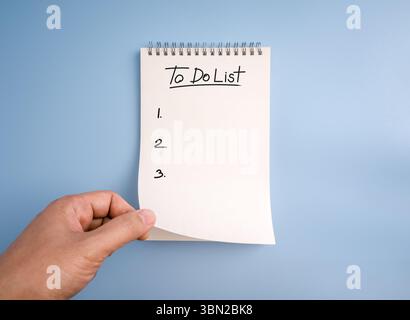 To do list, planning and checklist concept. "to do list," handwritten text font and list numbers on white page of tear-off memo pad, spiral notepad, o Stock Photo
