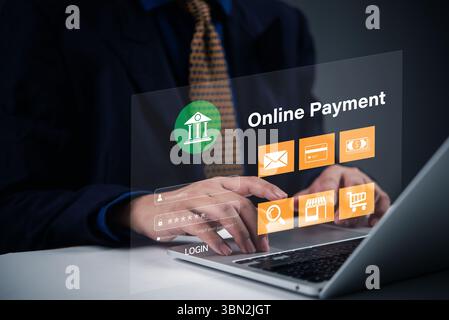 businessman is using a laptop with a virtual interface displaying online payment icons. This image is ideal for concepts related to digital banking, o Stock Photo