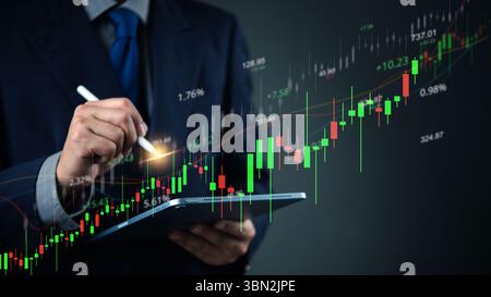 Close-up of hand using stylus on stock market chart on tablet. Ideal for stock trading, investment analysis, financial planning, and business growth c Stock Photo