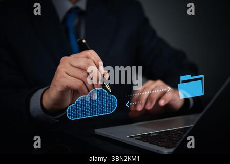 Businessman using cloud technology to transfer files to secure digital storage, concept for cloud computing solution and data backup. online managemen Stock Photo