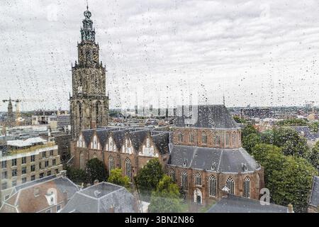 Scenic view of Martini church from through windows with raindrops of Forum building in the center of city of Groningen in The Netherlands Stock Photo