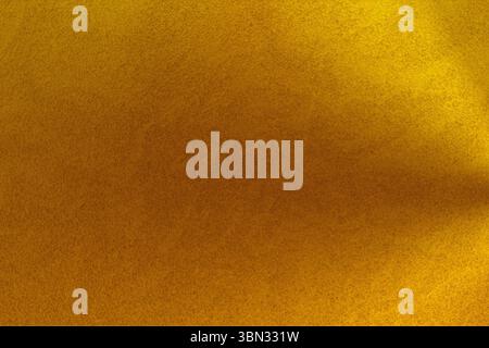 Granular textured surface is being shown in flat design close-up featuring yellow orange gradient Stock Photo