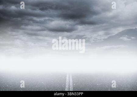 Flat design is showing paved road with double center stripes leading into fog under overcast clouds Stock Photo