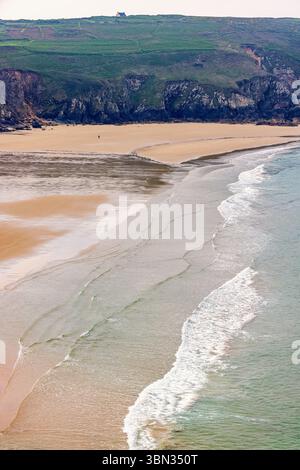 Sandy beach with waves rolling in Stock Photo