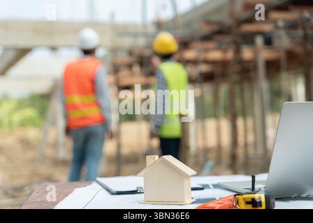 Engineers team use laptop and check the blueprint on site. Contractor and inspector inspection construction during project.civil Forman check quality Stock Photo
