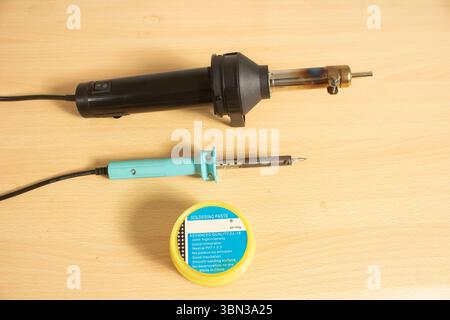 heat gun soldering iron and paste isolated on neutral background top down table top view Stock Photo