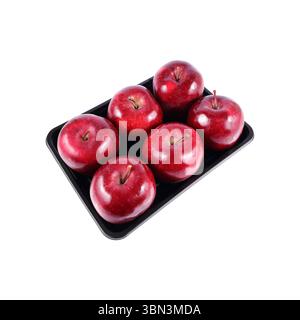 it is six red apples on black tray isolated on white. Stock Photo