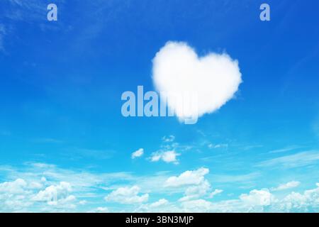 it is one white heart shaped cloud on blue sky. Stock Photo