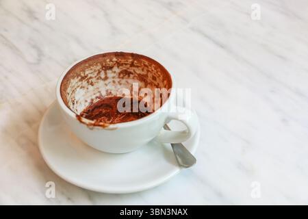 it is empty stained coffee cup on marble table. Stock Photo