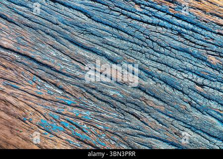 it is crack on wood texture with blue painted for background and design. Stock Photo