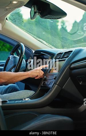 Hand pressing car engine start button. Starting vehicle using modern ignition technology. Person ready to driving car Stock Photo