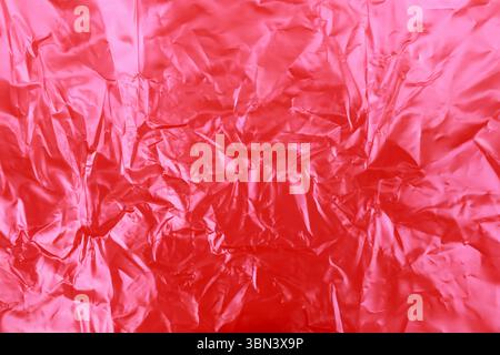 red wrinkled plastic texture background. Stock Photo
