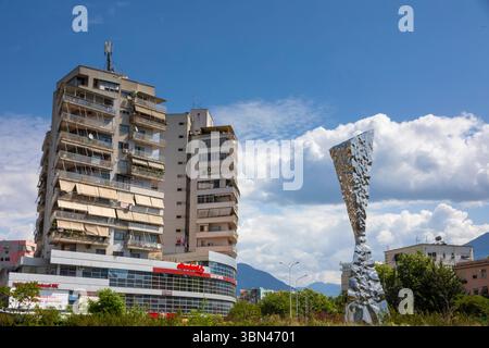 Tirana, Albania. Old buildings in the city center. Metal monument on the Rilindja traffic circle, Sheshi Karl Topia Stock Photo