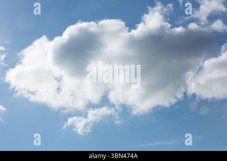 Flat design illustration is showing large fluffy cumulus cloud floating against bright blue sky Stock Photo