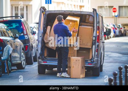 Paris suburbs, delivery man with a full van Stock Photo