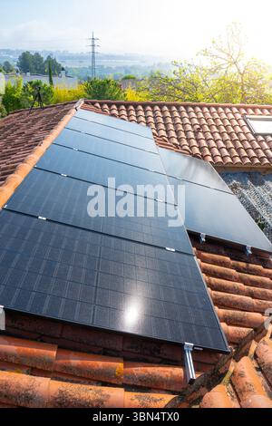 Solar Panels Installed on Roof in Bright Sunlight for Energy Generation and Efficiency Stock Photo