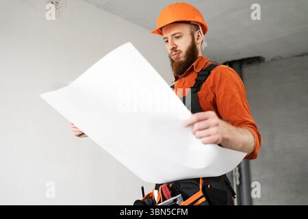 Bearded engineer builder with blueprints. Architect at construction site. Construction engineer with papers. Copy space Stock Photo