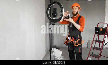 Handyman Broadcasting Construction Tips and Tricks During Home Project. Banner. Copy space Stock Photo