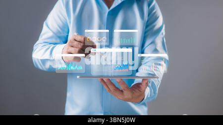 Businessman using a stylus to analyze interactive data dashboards on digital tablet screen. Data analytics, business intelligence, technology solution Stock Photo