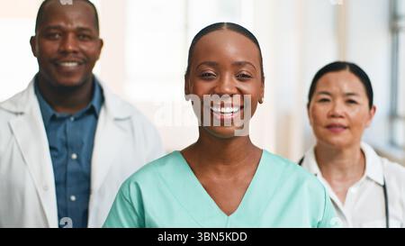 Group of Multiracial Medical Professionals Smiling Confidently in a Modern Hospital Setting Stock Photo