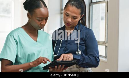 Healthcare Professionals Collaborating Using Digital Technology in a Clinical Setting Stock Photo