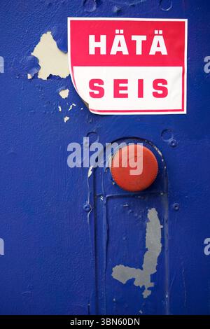 Red push button with a Finnish hätä seis (emergency stop) sticker Stock Photo